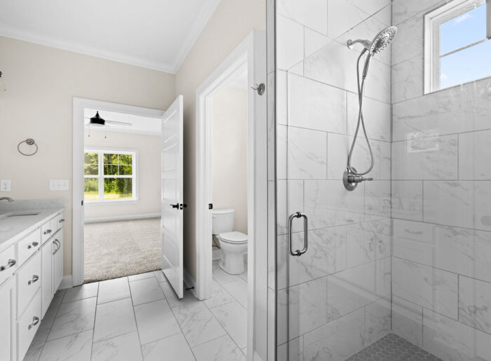 Spa inspired shower with expert tile work in new single level construction for sale