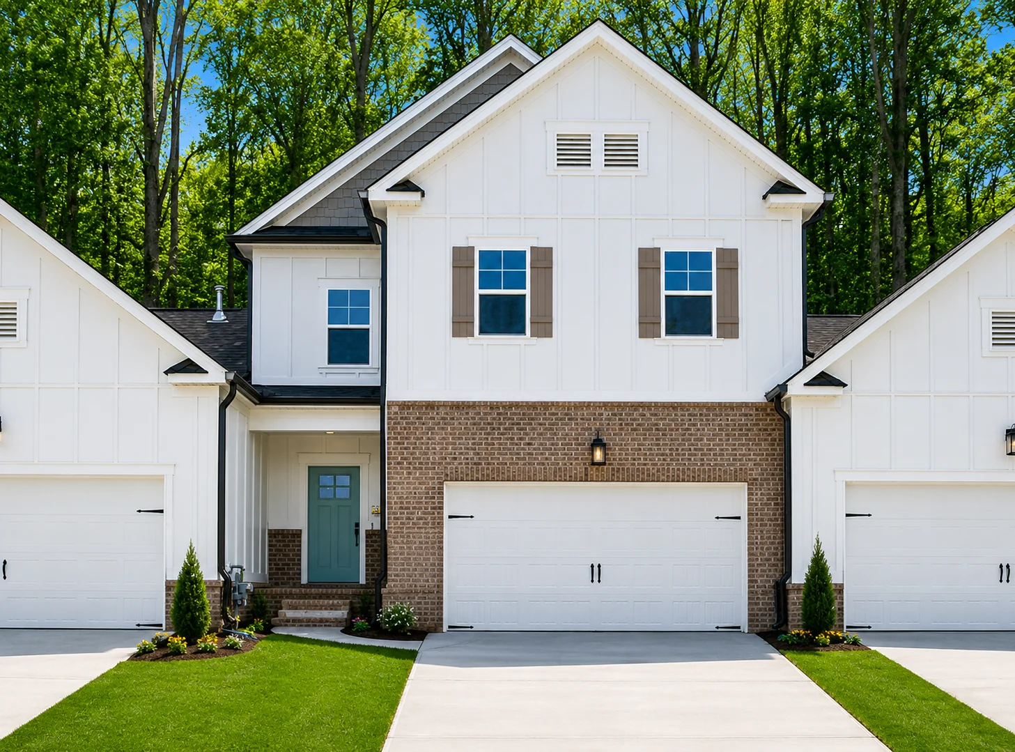 Blue-Ridge-floor-plan-front-exterior-home-for-sale Two-story house with brick and white siding, modern design by Pratt Home Builders in Chattanooga TN, featuring two garages and lush lawn.