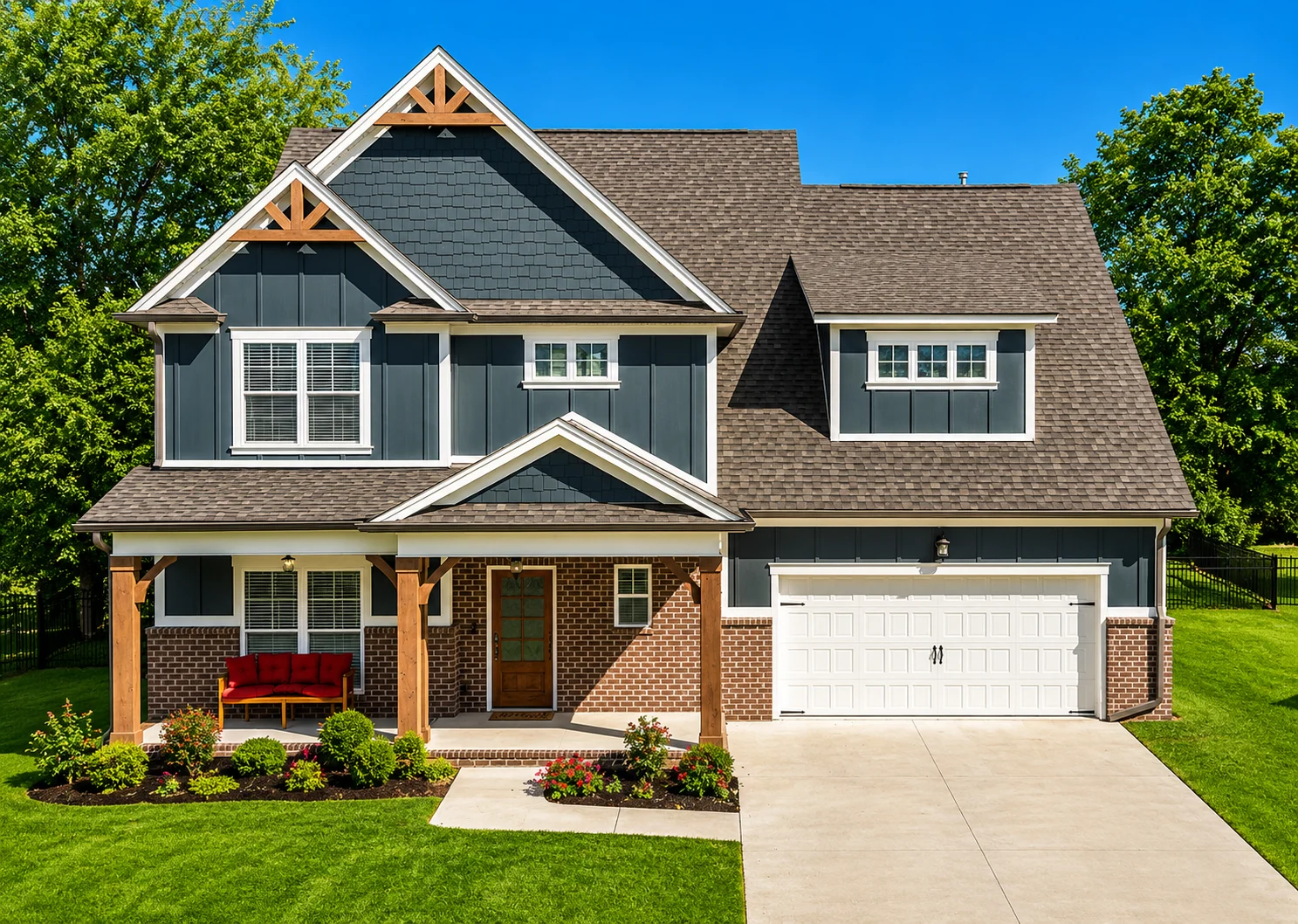 Calloway-floor-plan-front-exterior-home-for-sale Two-story house with gray siding, brick accents, and decorative trusses, built by Pratt Home Builders in Chattanooga TN, set against a green lawn.
