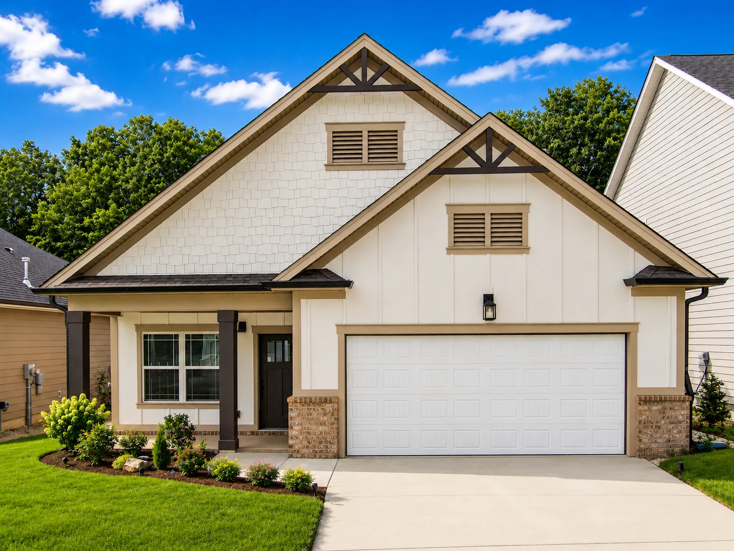 Chesapeake-floor-plan-front-exterior-home-for-sale Modern single-story home with beige siding, dark trim, and a double garage, built by Pratt Home Builders in Chattanooga TN, surrounded by greenery.