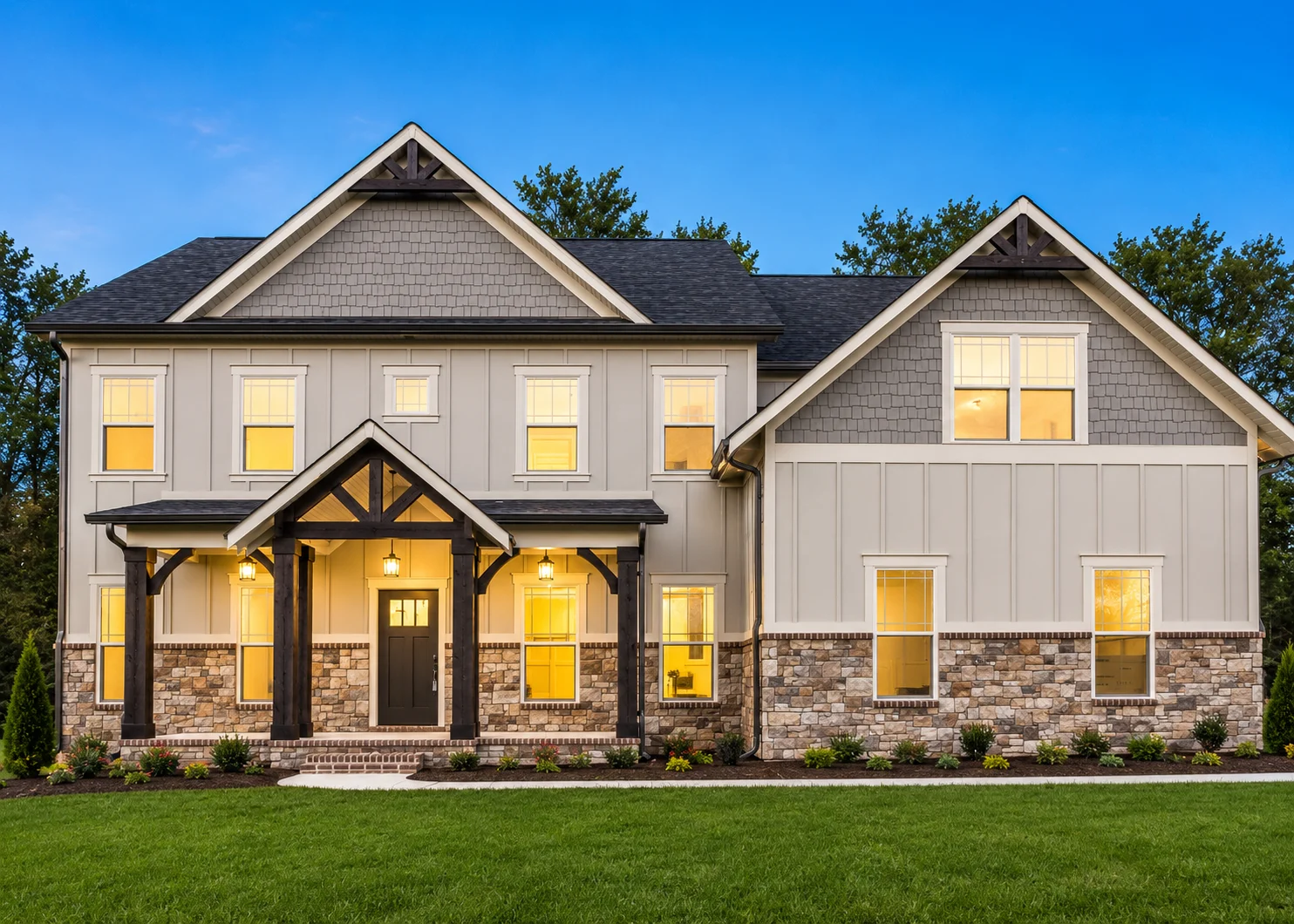 Chestnut-hill-floor-plan-front-exterior-home-for-sale Modern two-story home with stone and siding facade, lit warmly inside. Designed by Pratt Home Builders in Chattanooga TN.