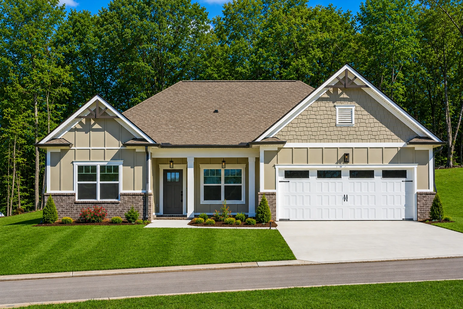 Charming beige craftsman home with a two-car garage, landscaped yard, by Pratt Home Builders in Chattanooga TN, framed by lush green trees.
