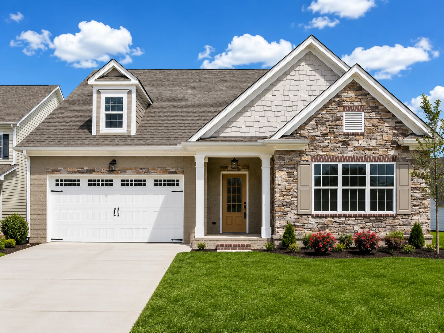 Laurel-floor-plan-front-exterior-home-for-sale Modern suburban home with stone facade, gabled roof, and manicured lawn. Built by Pratt Home Builders in Chattanooga, TN. Bright, sunny day.