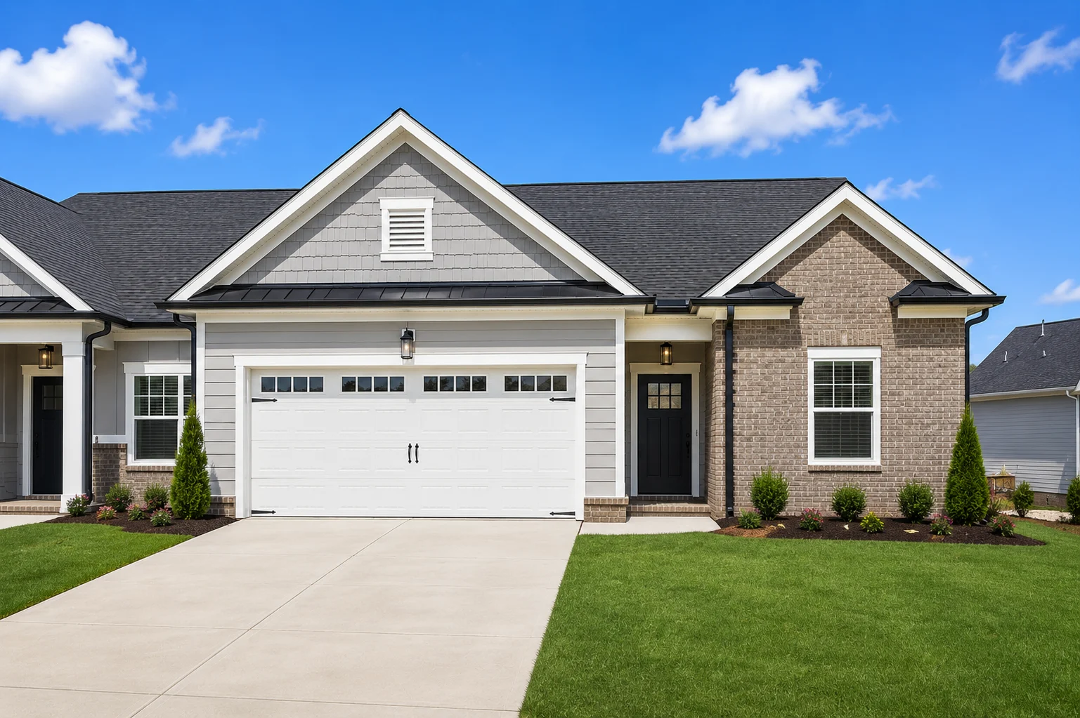 Modern single-story home with a two-car garage, built by Pratt Home Builders in Chattanooga TN, featuring brick and siding exterior.