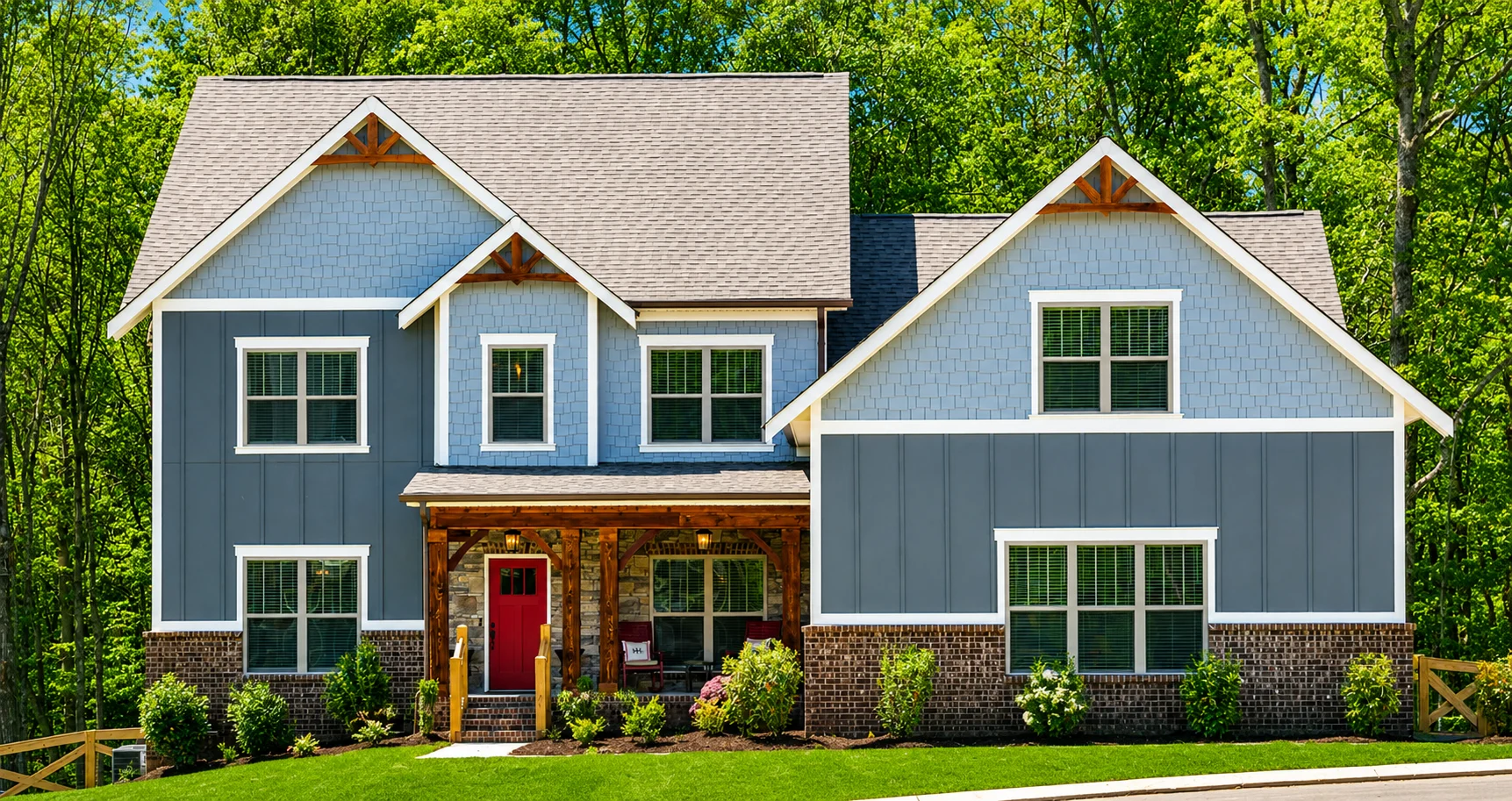 Shenandoah-floor-plan-front-exterior-home-for-sale Two-story blue house with a red door, stone and brick accents, surrounded by trees, built by Pratt Home Builders in Chattanooga TN.