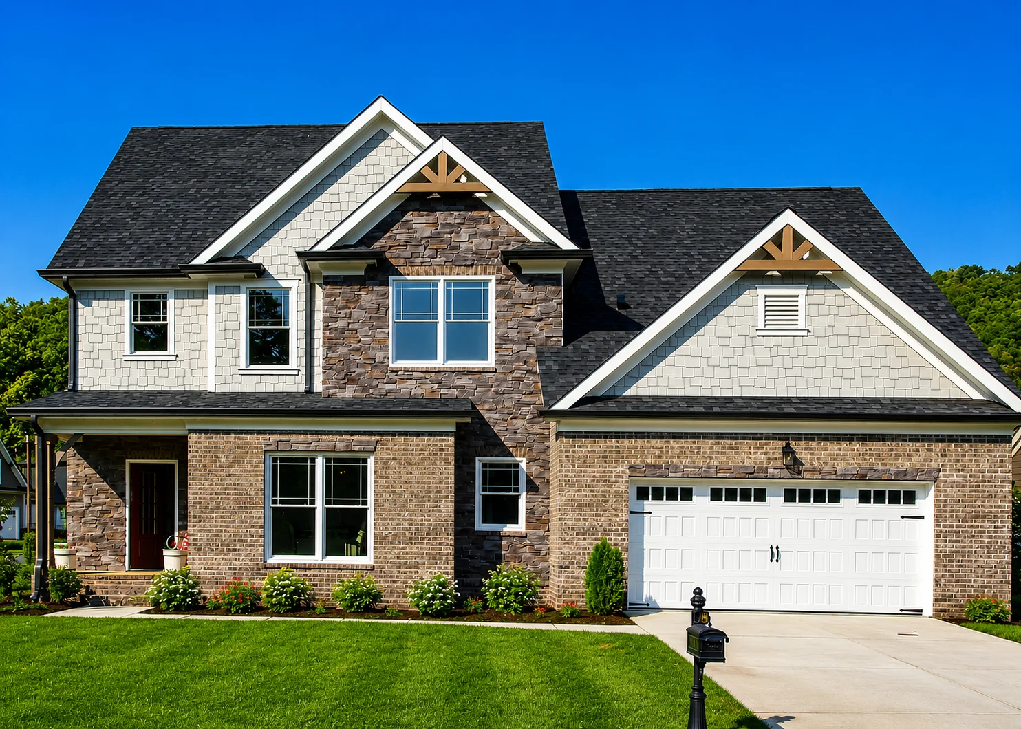 Stillwater-floor-plan-front-exterior-home-for-sale Modern two-story house with stone and brick facade, black roof, and manicured lawn, built by Pratt Home Builders in Chattanooga, TN.