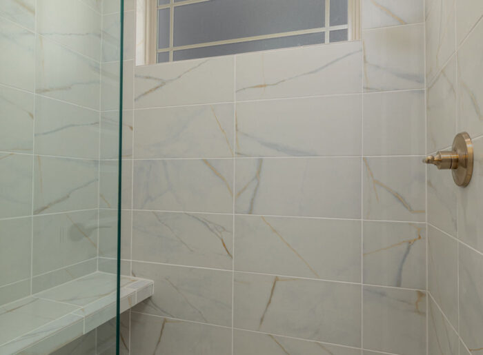 Expert tile work and built-in bench primary shower