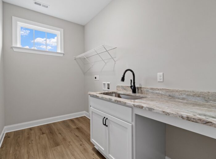 Large laundry room with folding space and shelving