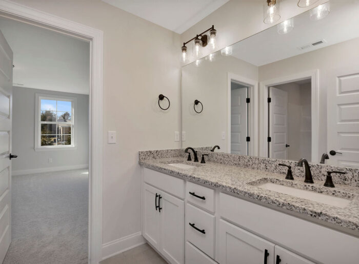 Primary bathroom with double vanity and designer finishes move-in ready