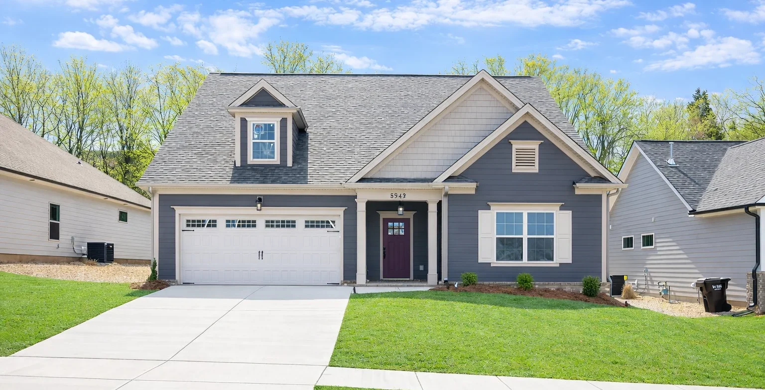 New Home Chattanooga TN. Gray single-story house with white garage, green lawn, built by Pratt Home Builders.