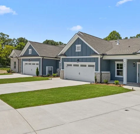 Modern townhome with blue and gray brick exteriors, built by Pratt Home Builders in Chattanooga TN, featuring spacious garage and covered patios in Engel Park.