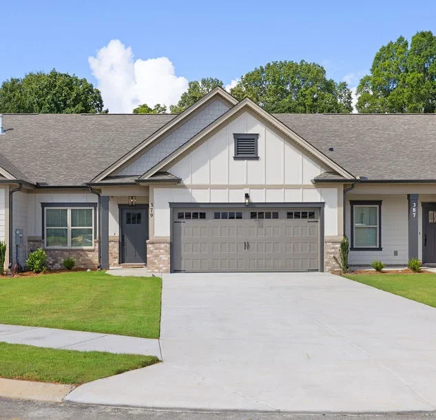 Single-story townhouse with a two-car garage and manicured lawn, built by Pratt Home Builders in Chattanooga, TN.
