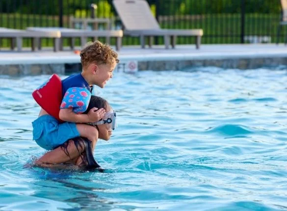Kids playing in Pratt Home Builders community pool in new construction selling now Community Pool and Cabana by Pratt Home Builders in Chattanooga TN.