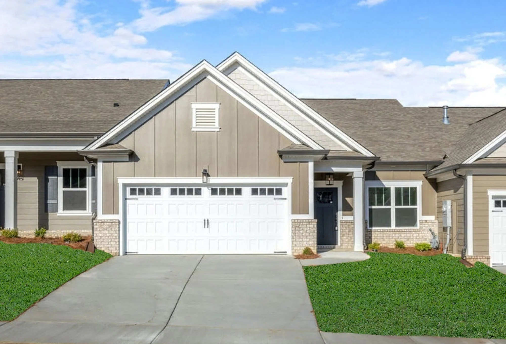 New Home Chattanooga TN. Modern suburban home with beige siding and white garage, built by Pratt Home Builders. Manicured lawn and clear blue sky.