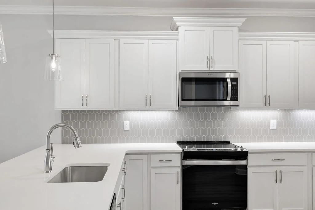 Modern kitchen with sleek cabinetry, stainless steel appliances, and elegant lighting by Pratt Home Builders in Chattanooga TN.