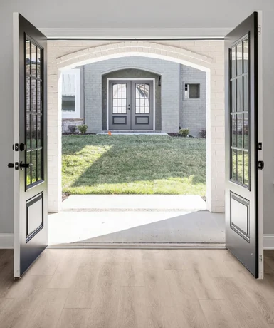 Luxury Comes Standard Open double doors leading to a sunlit patio and grassy yard, featuring elegant architecture by Pratt Home Builders in Chattanooga TN.