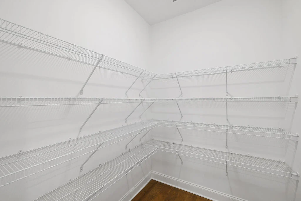 White wire shelves in a walk-in pantry built by Pratt Home Builders in Chattanooga TN, offering ample storage space.