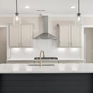 Kitchen Modern kitchen design with marble island, pendant lights, sleek faucet, and cabinetry by Pratt Home Builders in Chattanooga TN.