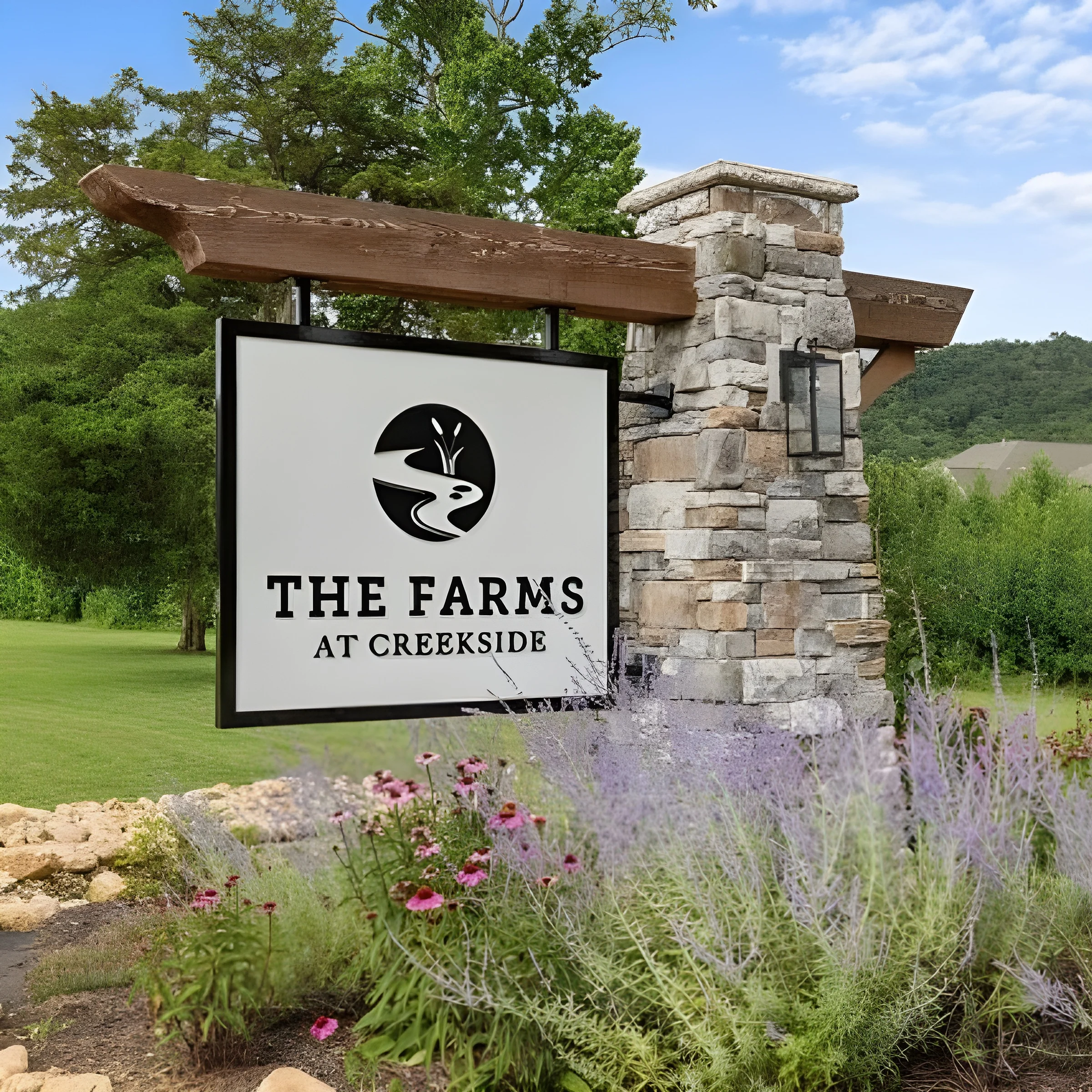The Farms at Creekside Sign reading "The Farms at Creekside" mounted on a stone pillar, surrounded by lush greenery and flowers; a Pratt Home Builders project in Chattanooga