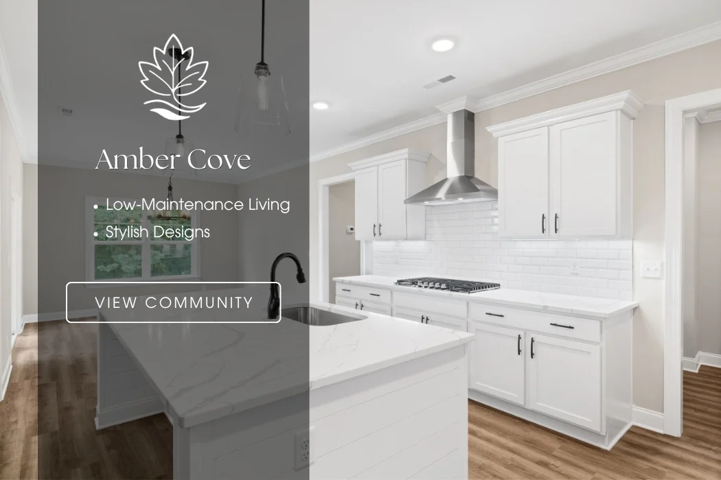 Amber Cove kitchen by Pratt Home Builders in Chattanooga TN, featuring sleek white cabinets, modern appliances, and wood flooring.