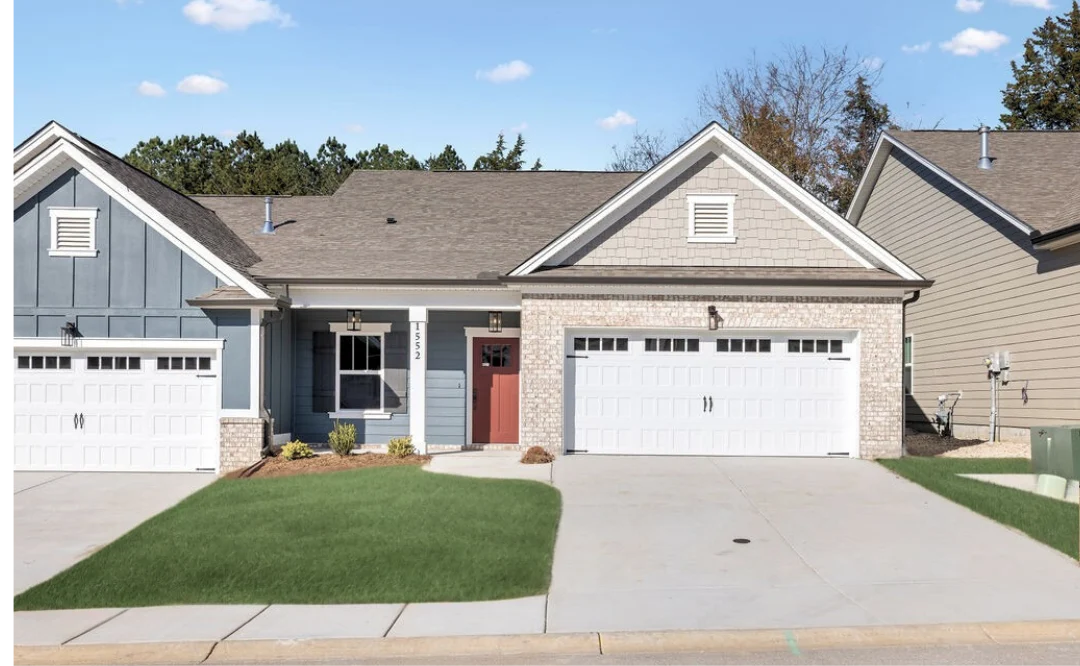 Modern suburban house with blue siding, red door, and double garage. Built by Pratt Home Builders in Chattanooga TN.
