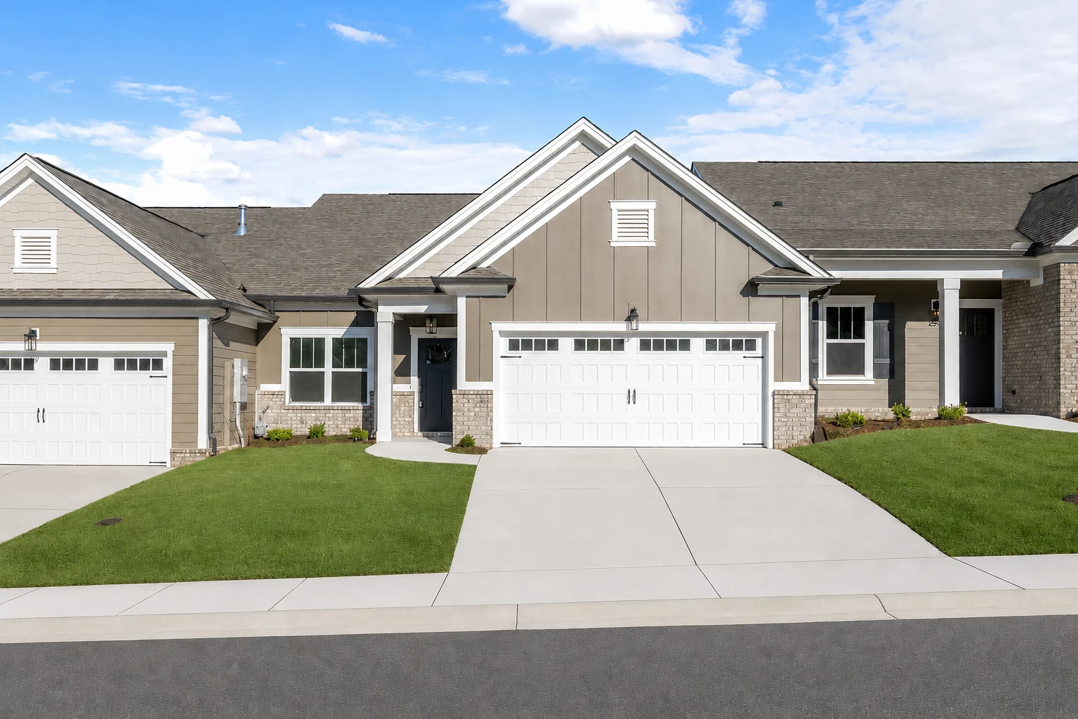 Modern suburban home with neat lawn, two-car garage, and siding in neutral tones by Pratt Home Builders in Chattanooga TN.