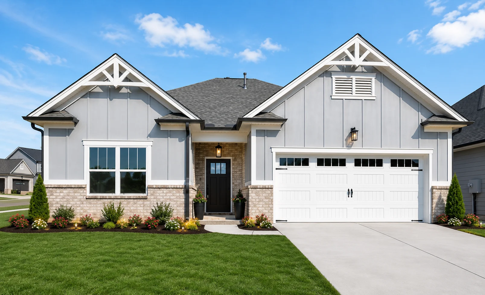 Modern gray and brick home with manicured lawn, black front door, and white garage, built by Pratt Home Builders in Chattanooga, TN.