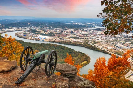Historic cannon on Lookout Mountain overlooking Chattanooga, TN, amidst autumn foliage; nearby Pratt Home Builders in Chattanooga TN.